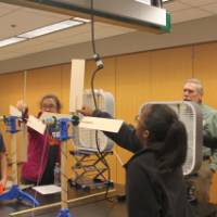 Students playing with wind turbine blades